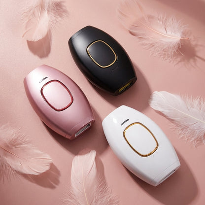 Three hair removal devices in black, pink, and white on a pink feathered background