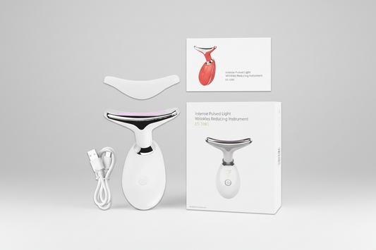 White skincare device with packaging and accessories on a white background